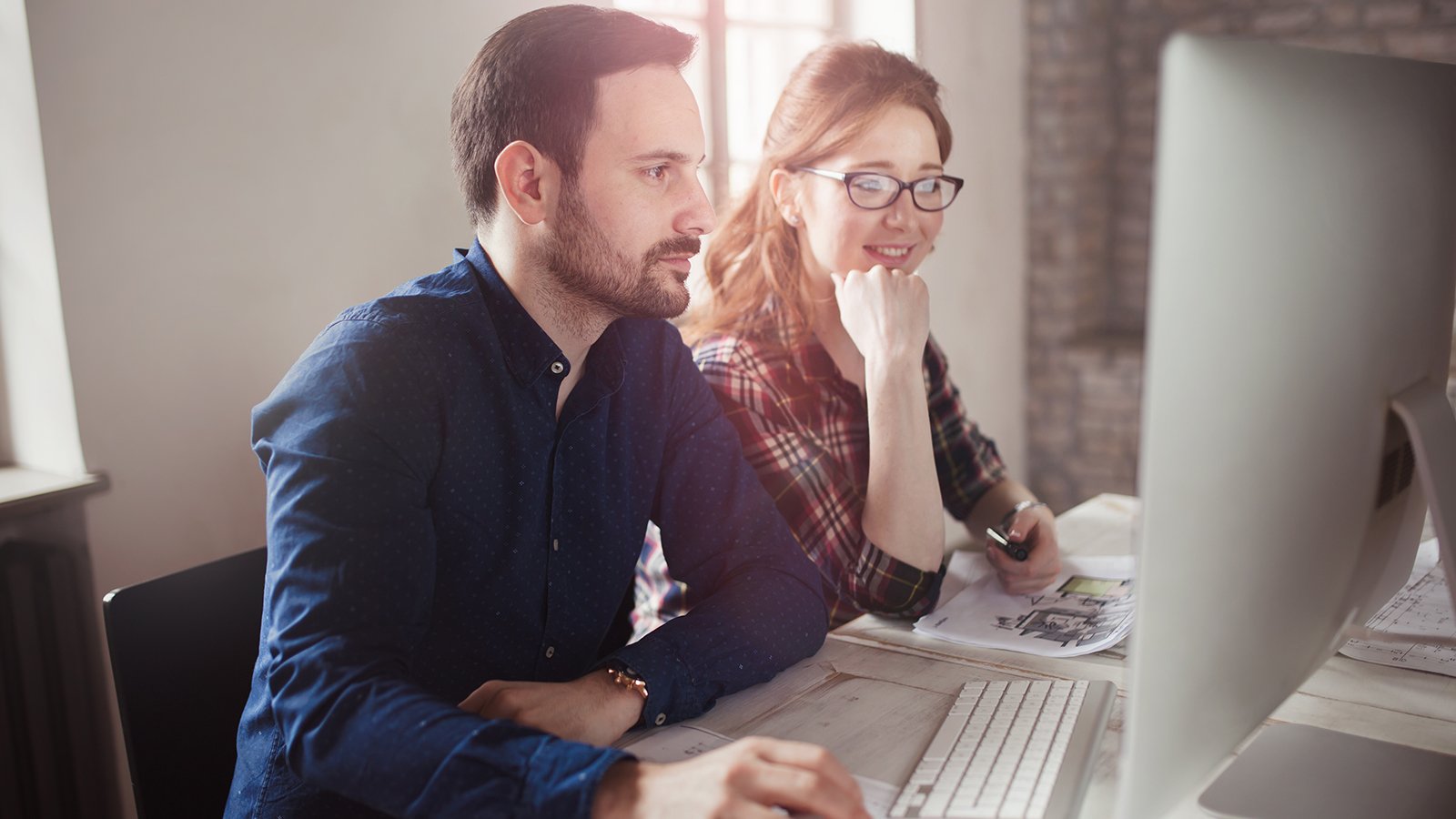 Man and woman working on a computer