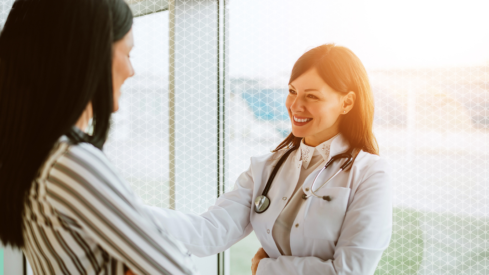 Doctor is discussing with patient with smile