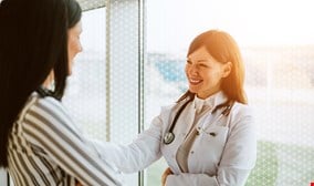 Doctor is discussing with patient with smile