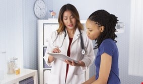 Doctor is discussing with patient with smile