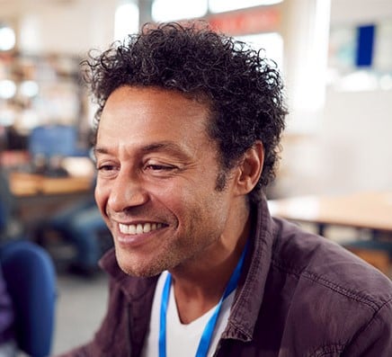A young employee smiling at workplace
