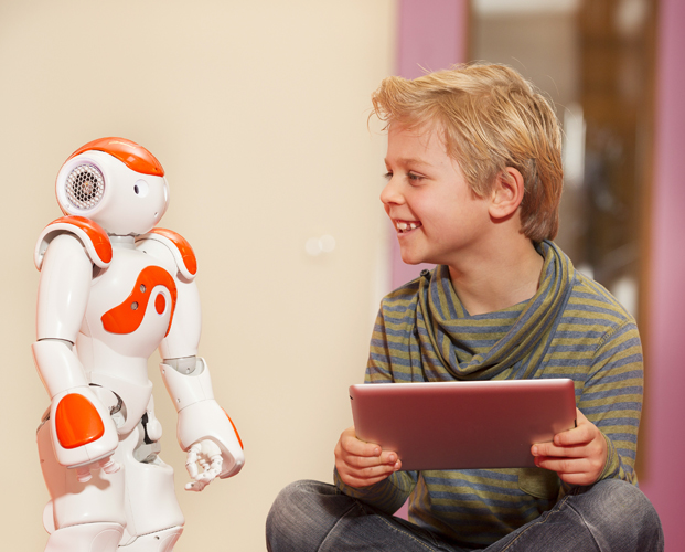 A boy with robot and tablet computer