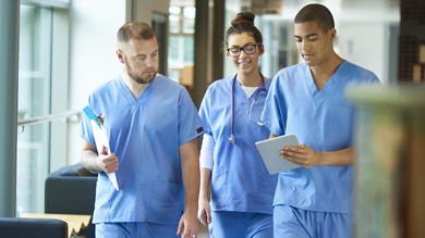 Group of medical staff discussing in clinic hallway