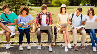 Group of people sitting and working on their laptop