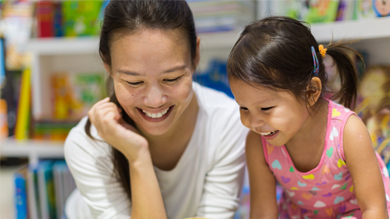 Mom and daughter smiling