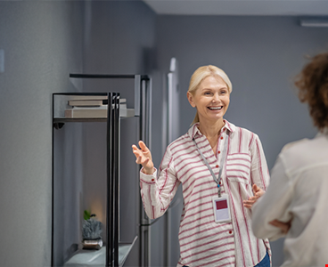 Assistant showing shop to customer