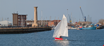 A Boat Sailing in a Marina