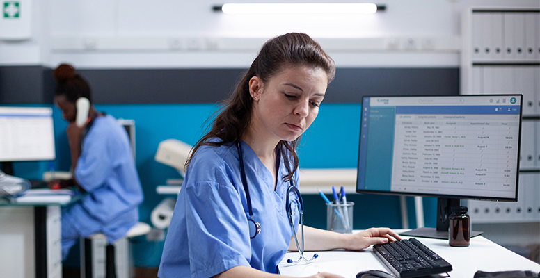 Caucasian nurse checking appointment data notes