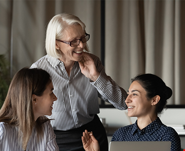 diverse female office team discussing project