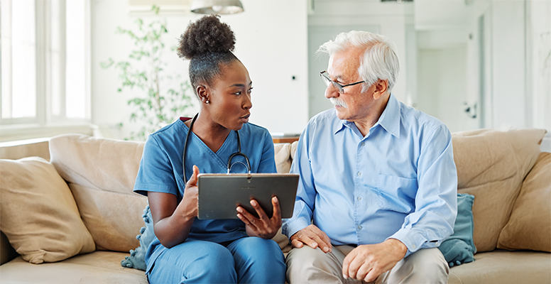 Doctor nurse caregiver showing tablet screen