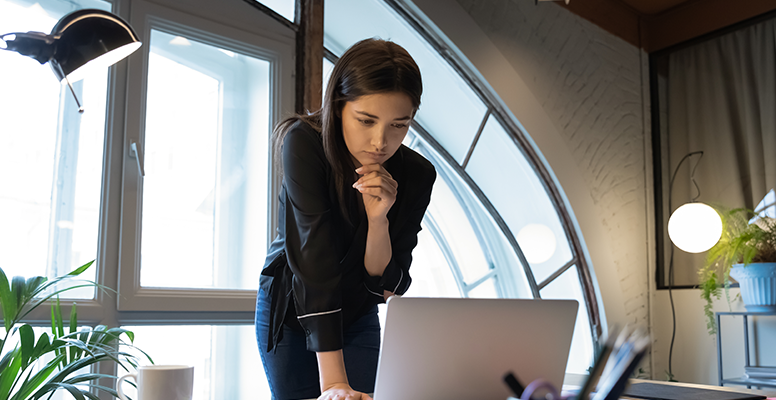 Girl-thinking-and-looking-towards-laptop