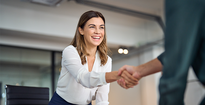 Happy business woman shaking hand
