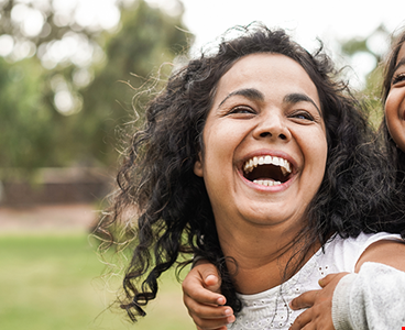 Happy indian mother having fun her daughter