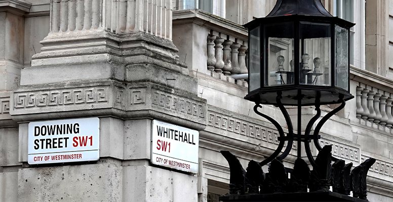 Downing Street and Whitehall street signs on the corner