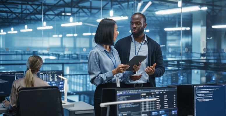Male DevOps Engineer and Female IT Consultant Using a Tablet Computer