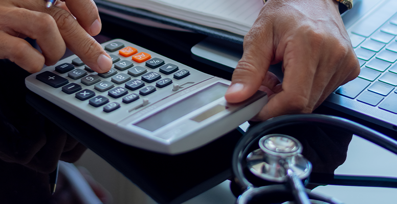 man using calculator on table