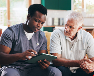 Nurse elderly man talk tablet