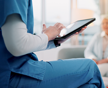 Nurse typing for counseling and checking details on tablet