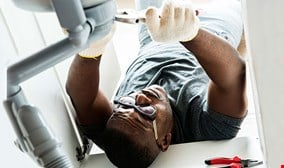 Plumber man fixing kitchen sink