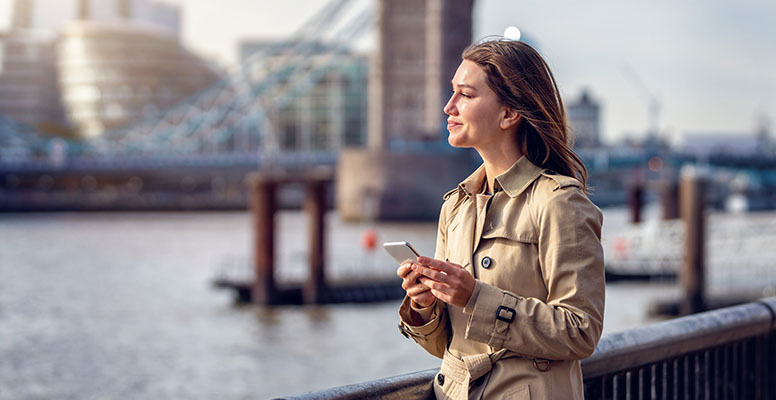 Portrait of a trendy business woman holding a mobile phone
