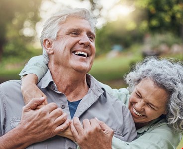 Senior couple hugging in park, garden and retirement to relax