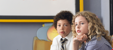 thoughtful-elementary-students-sitting-classroom