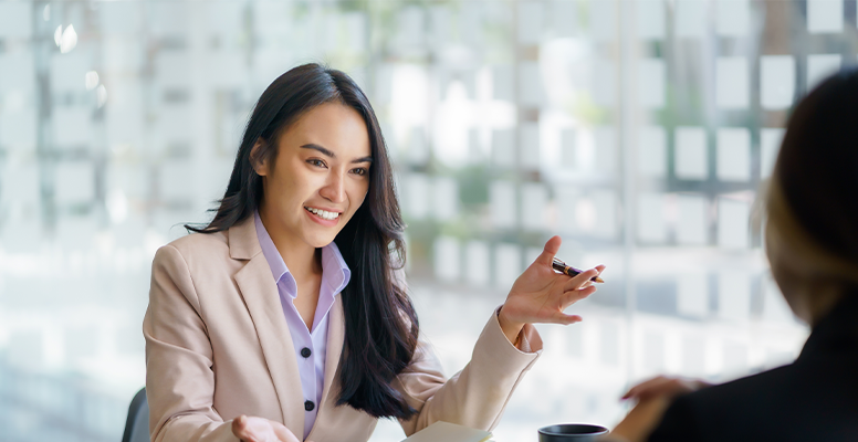 Two beautiful young asian businesswoman conversation