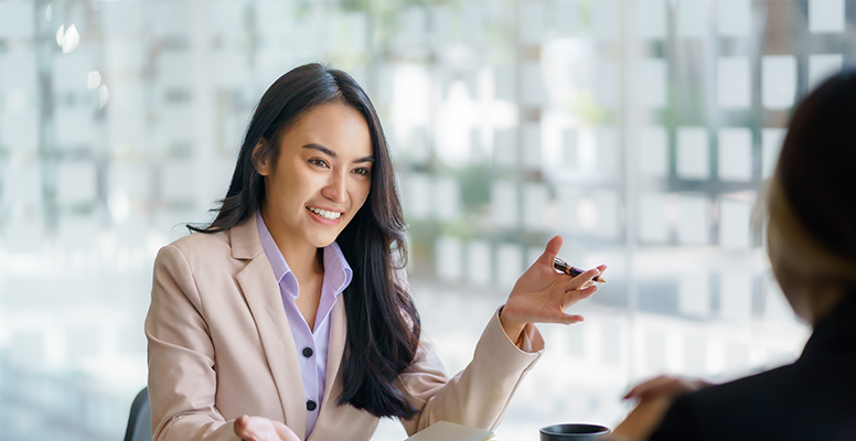 Two beautiful young businesswoman conversation