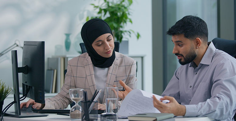Two business people team in office working
