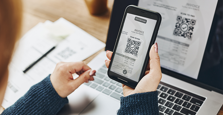 Woman scanning qr code invoice make
