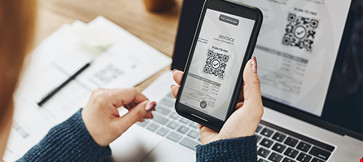 Woman scanning qr code invoice make