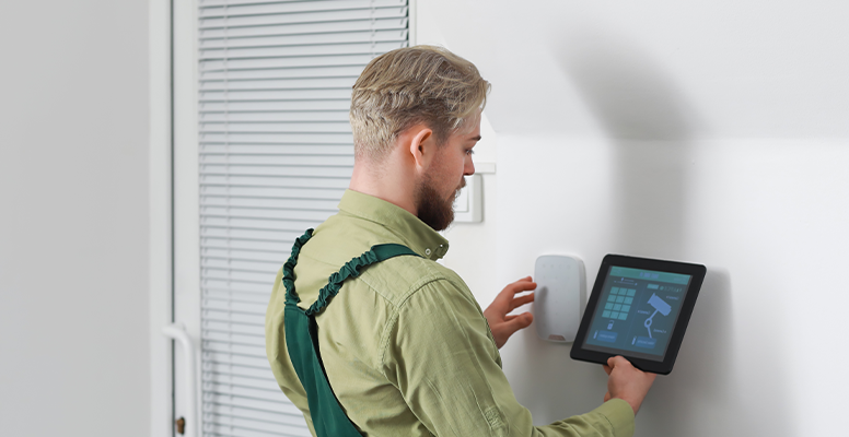 Worker tablet computer checking alarm system