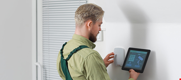 Worker tablet computer checking alarm system