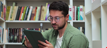 Young man in glasess sitting on the floor