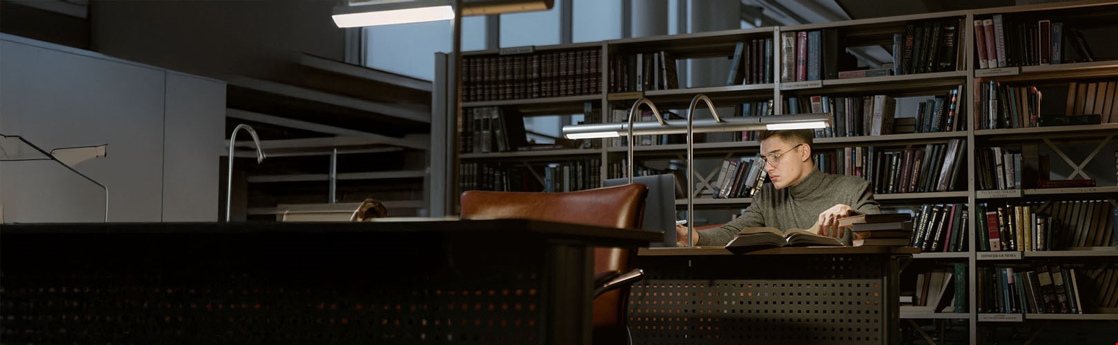 A man reading books in the library 