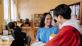 Asian girl reading in the library