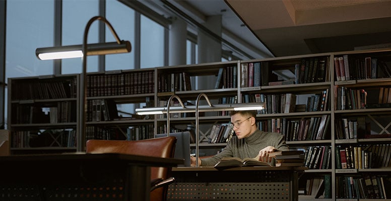 people-studying-in-the-library-and-choosing-books-for-reading