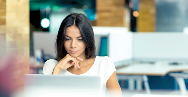 Portrait of a serious businesswoman using- aptop in office