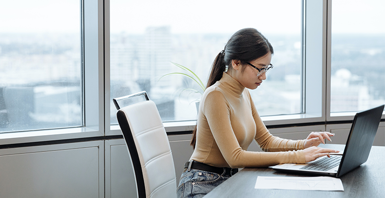 Young businesswoman sitting at work desk