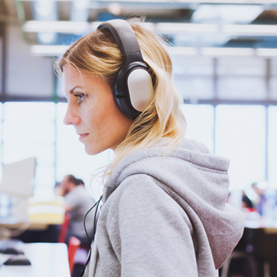 Adult education student in headphones working on computer