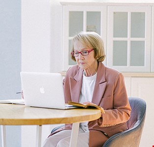 Old age woman working on laptop