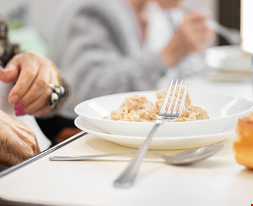 close-elderly-woman-having-lunch-retirement